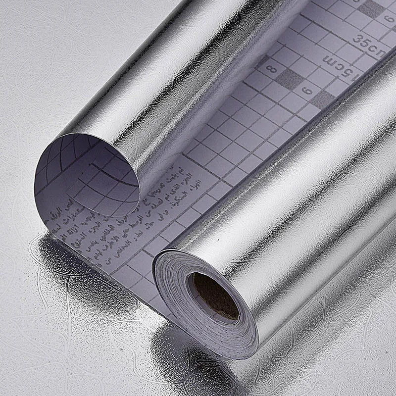 Roll of silver aluminum foil wall decals showing a grid pattern and measurement markings