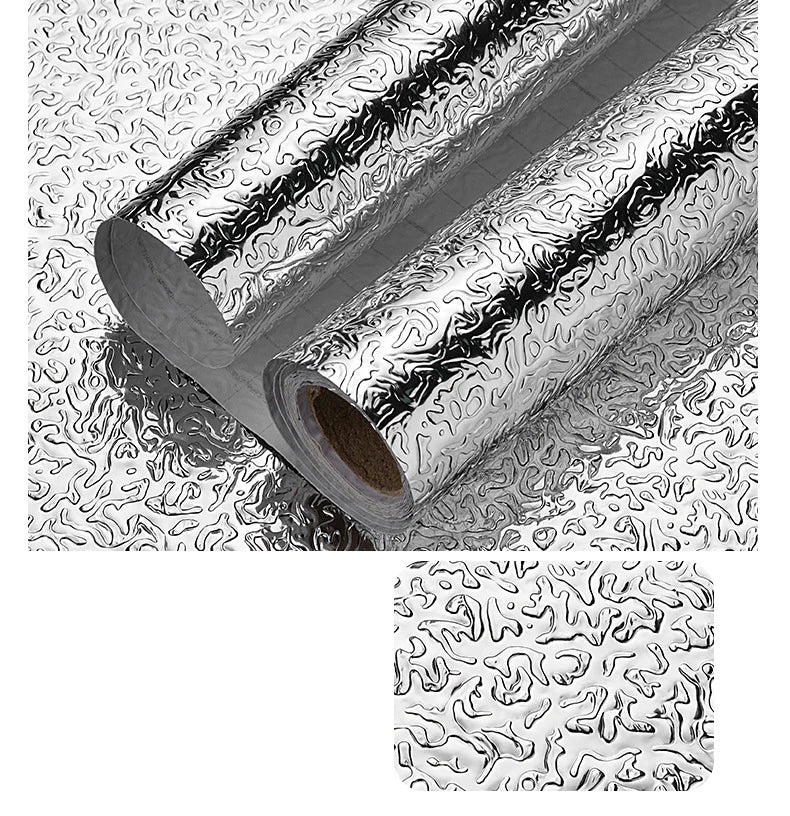 A close-up view of self-adhesive aluminum foil wall decals rolled up, showing a textured pattern.