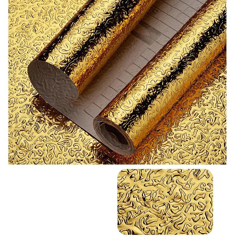 Rolls of self-adhesive aluminum foil wall decals showing a gold textured pattern.