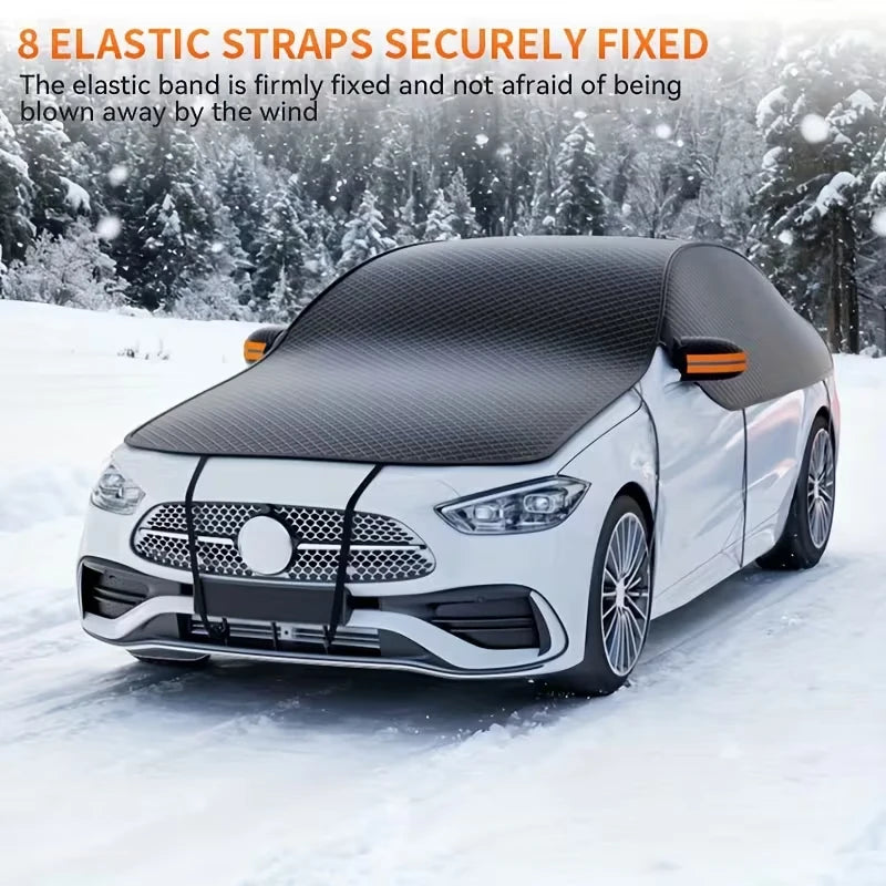 A white car is shown with a black elastic strap windshield cover secured on it in a snowy outdoor setting.