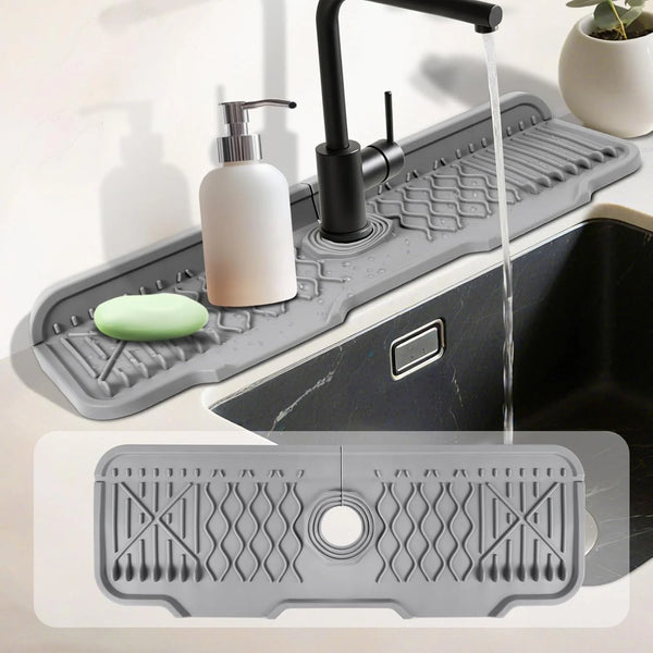 A silicone kitchen sink splash guard and drying pad with a faucet and soap dispenser shown in use.