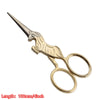 Gold-toned vintage tailor scissors with a floral embroidery design and pointed tips.
