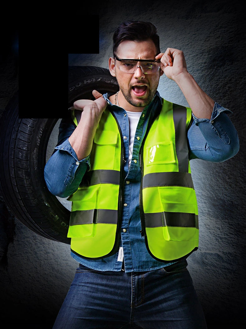 A man wearing a neon yellow high-visibility safety vest and glasses, looking intensely at the camera.
