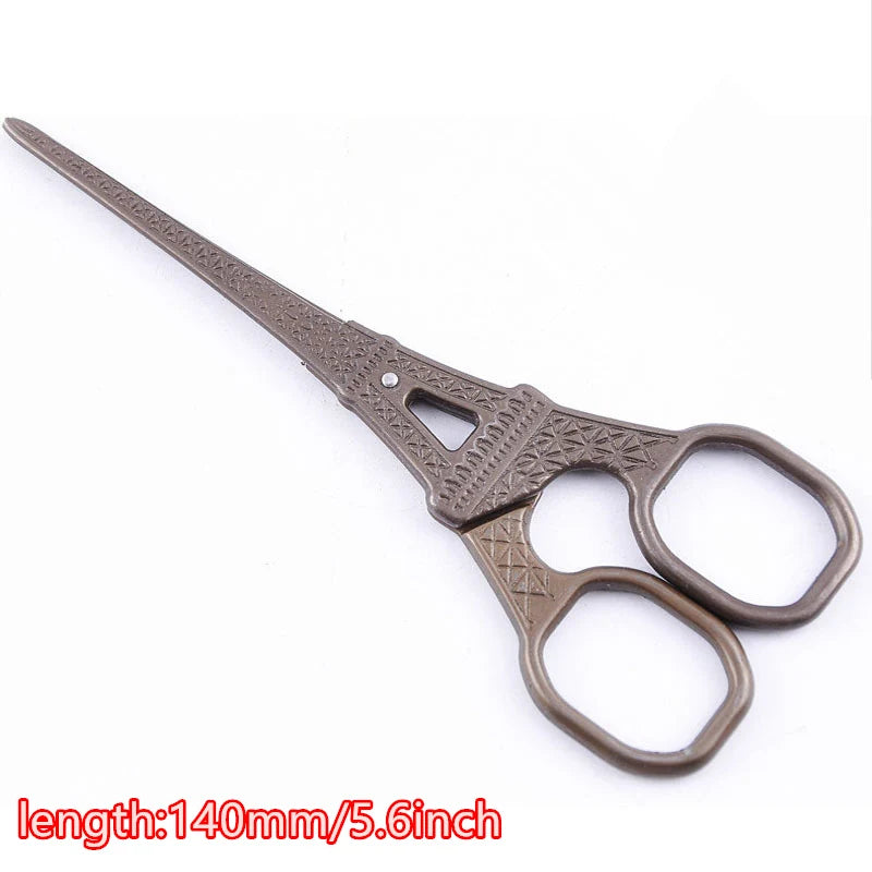 Vintage floral embroidery tailor scissors with a long, slender blade and dark metal handles