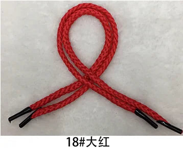 A red gift wrapping rope tied in a bow, showing the texture and thickness of the cord.