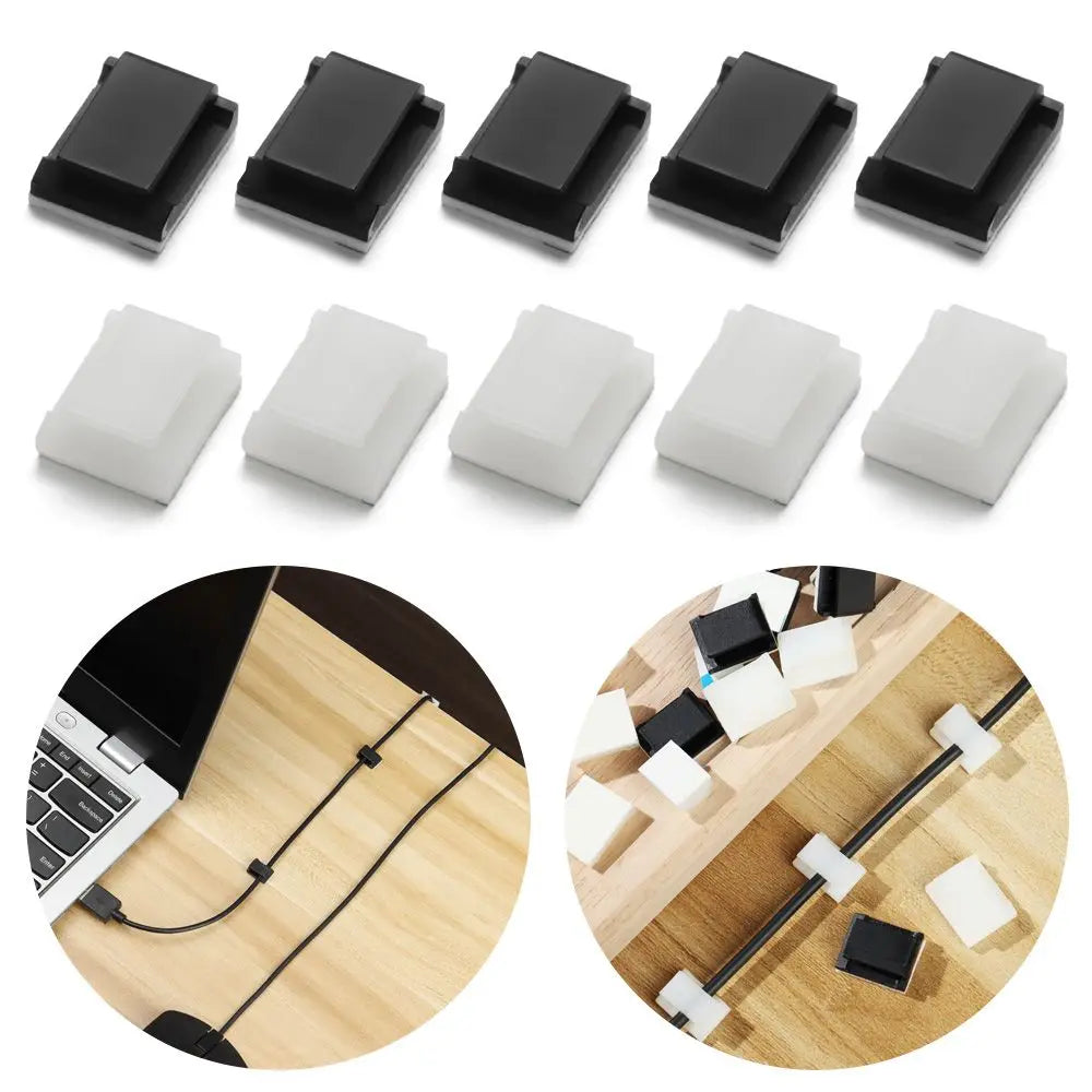 A set of black and white self-adhesive cable clips used for organizing cords and cables.