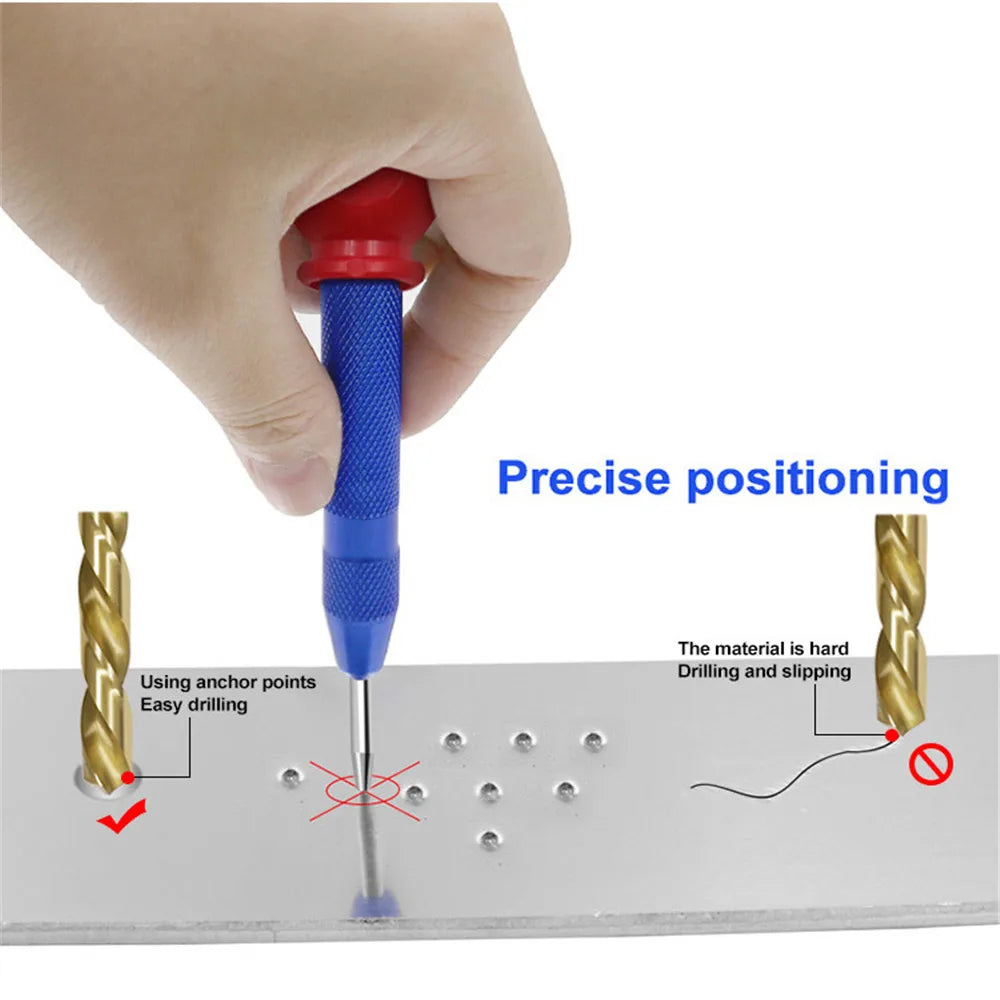 A hand is using a blue and red spring-loaded center pin punch to achieve precise positioning on a metal surface.