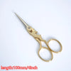 Vintage gold-colored tailor scissors with a floral embroidery design