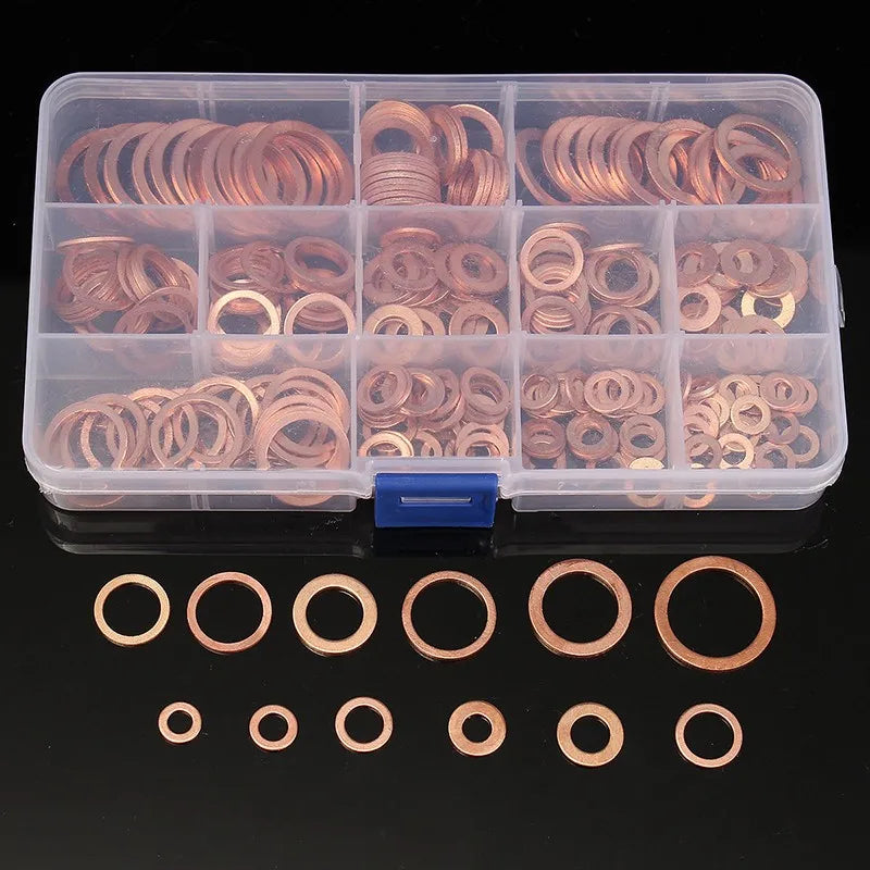 A clear plastic container holds various copper sealing washers and sump plugs.