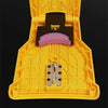 A yellow portable chainsaw tooth sharpening kit with a black sharpening block and metal inserts.