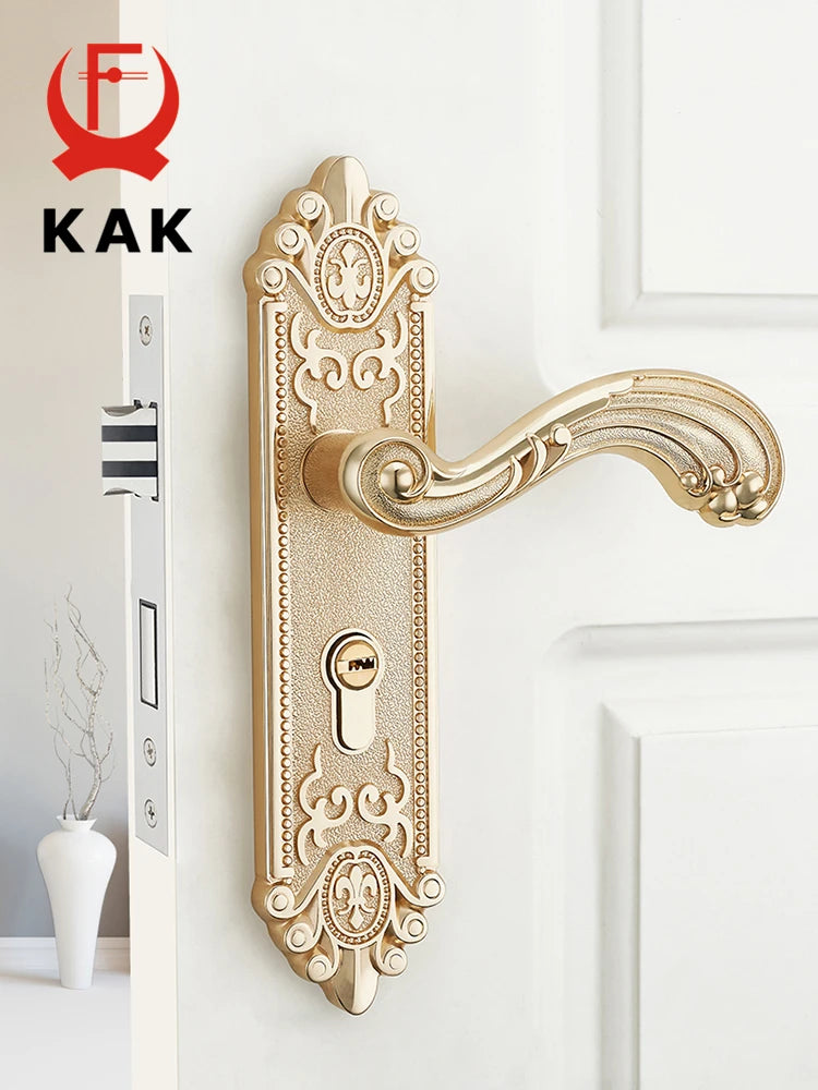 A close-up of a European style gold door lock with keys mounted on a white wall.