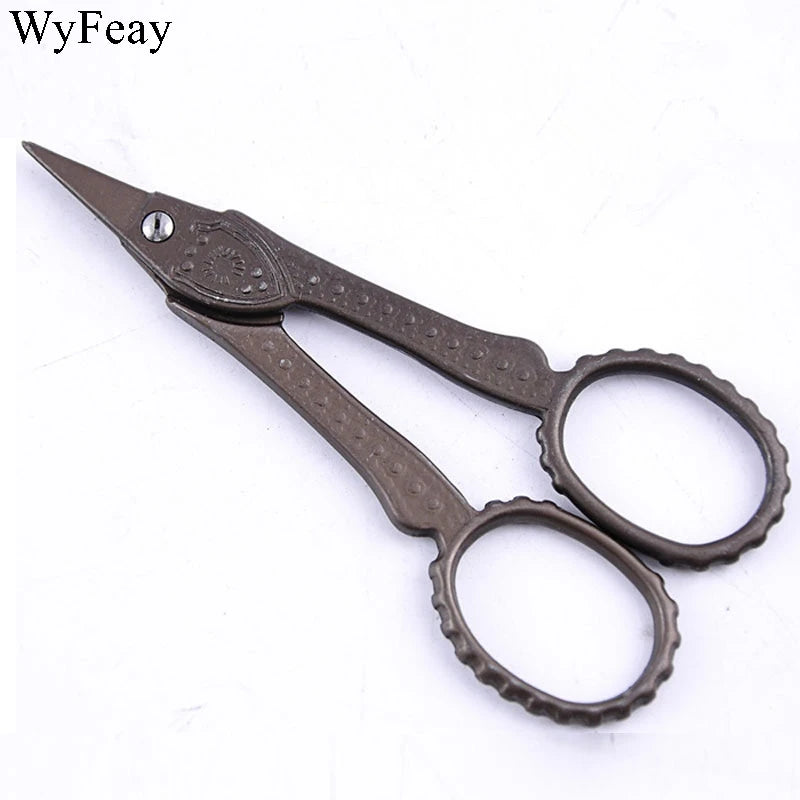 Vintage floral embroidery tailor scissors with dark metal handles and pointed blades