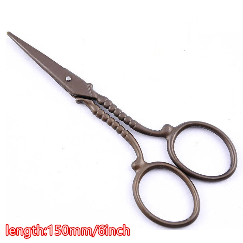 Vintage floral embroidery tailor scissors with a dark brown handle and silver tip