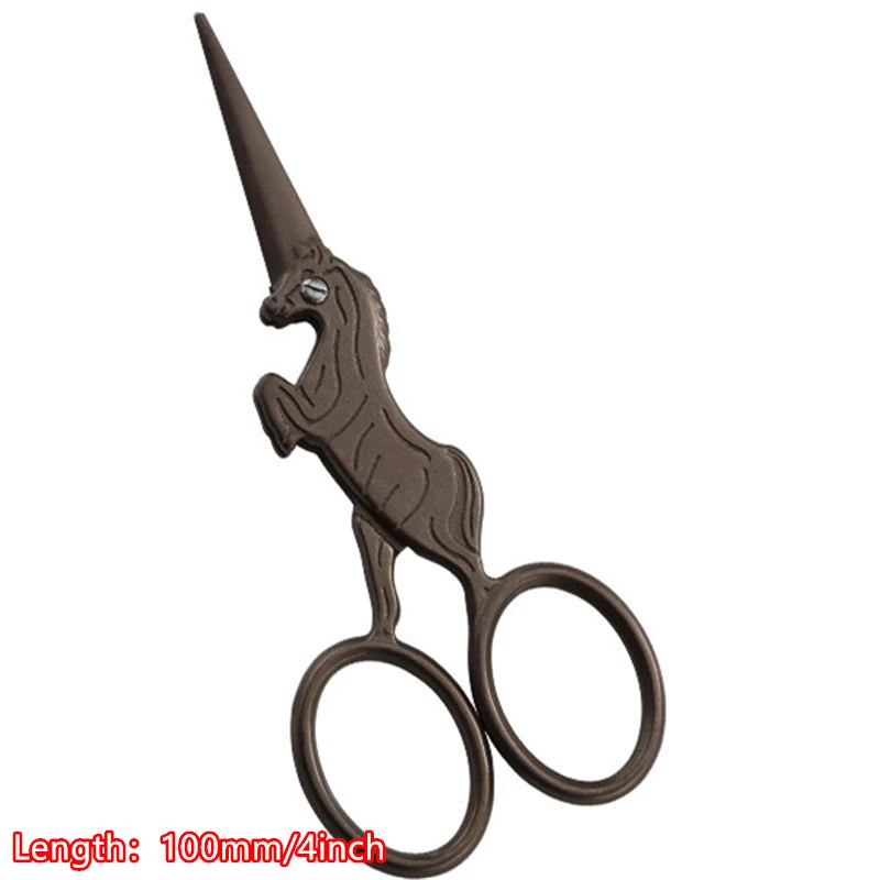 A vintage floral embroidery tailor scissor with a dark brown handle and pointed blades.