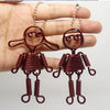 Paar anodisierter Metall-Schmuck-Ohrringe in rostbrauner Farbe mit stilisiertem Figuren-Design