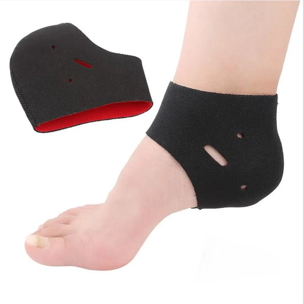 Black therapy heel socks applied to the sole of a foot for plantar fasciitis relief.