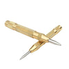 A gold-colored spring-loaded center pin punch tool for woodworking and repair.