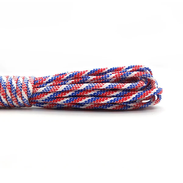A coil of heavy duty 7-strand paracord rope with a red, white, and blue pattern.
