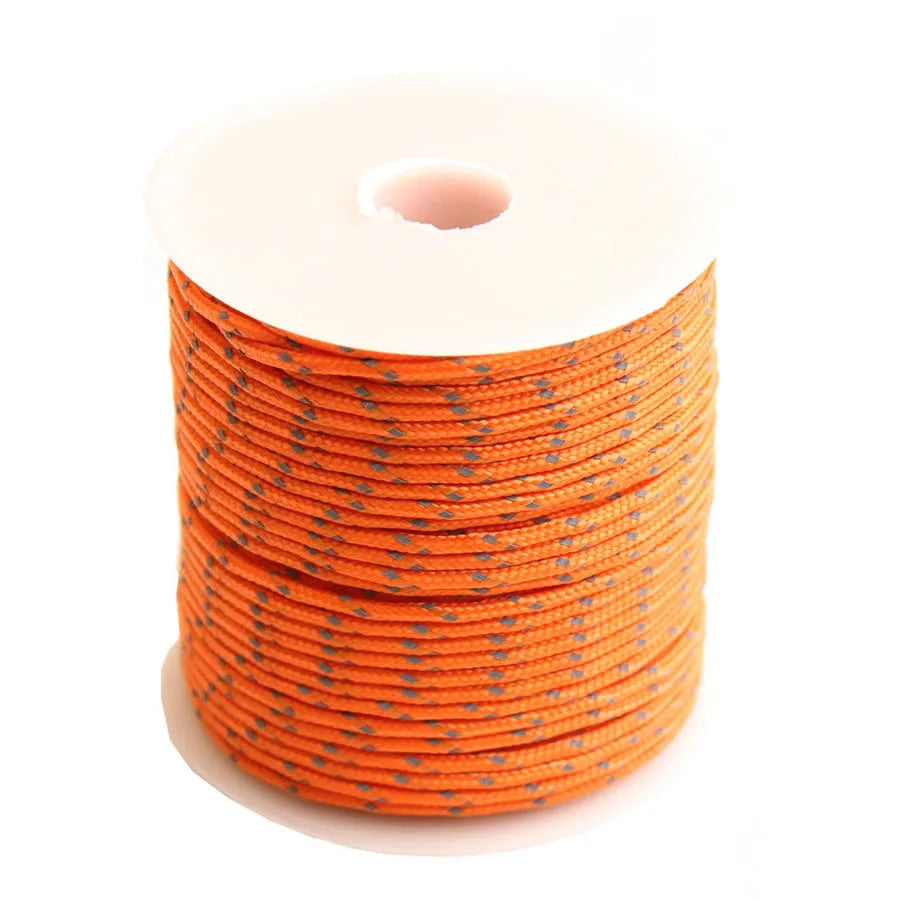 A spool of orange reflective paracord rope coiled on a white background.