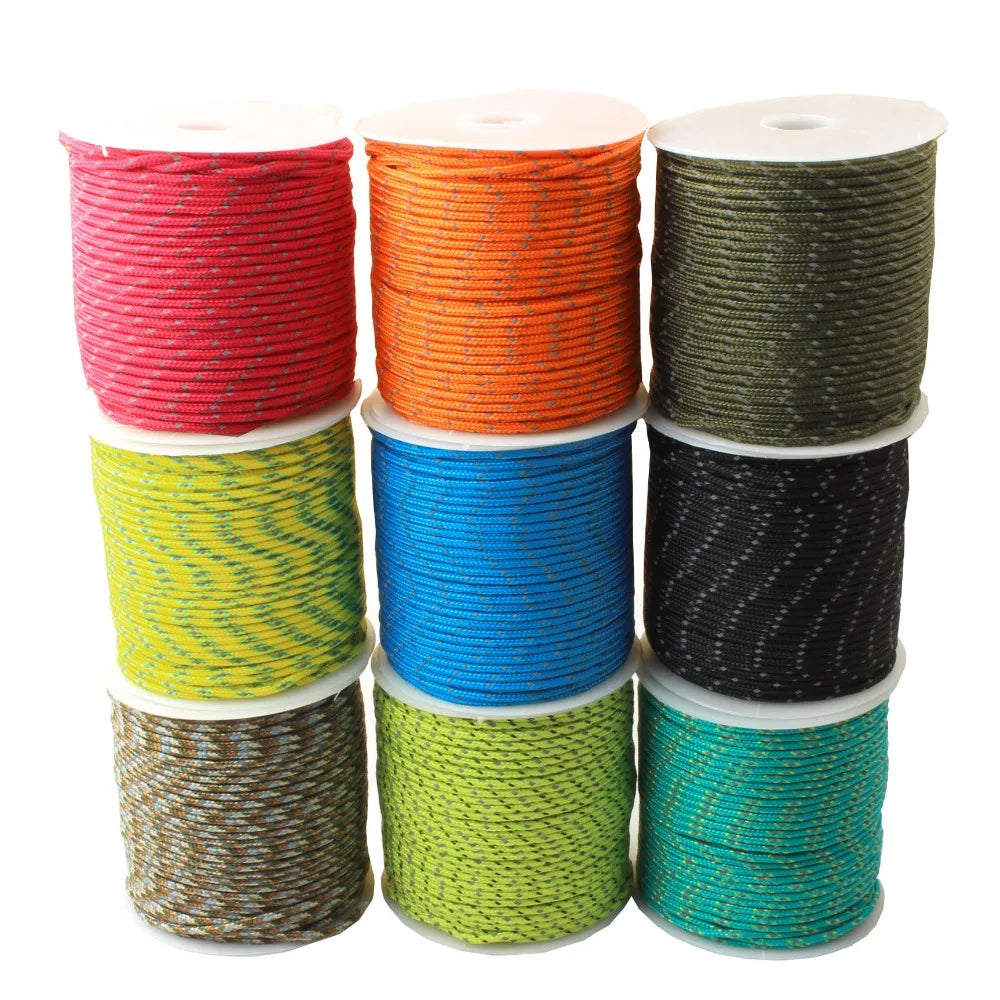 A stack of spools of durable 2mm reflective paracord rope in various colors including red, orange, green, blue, and black.