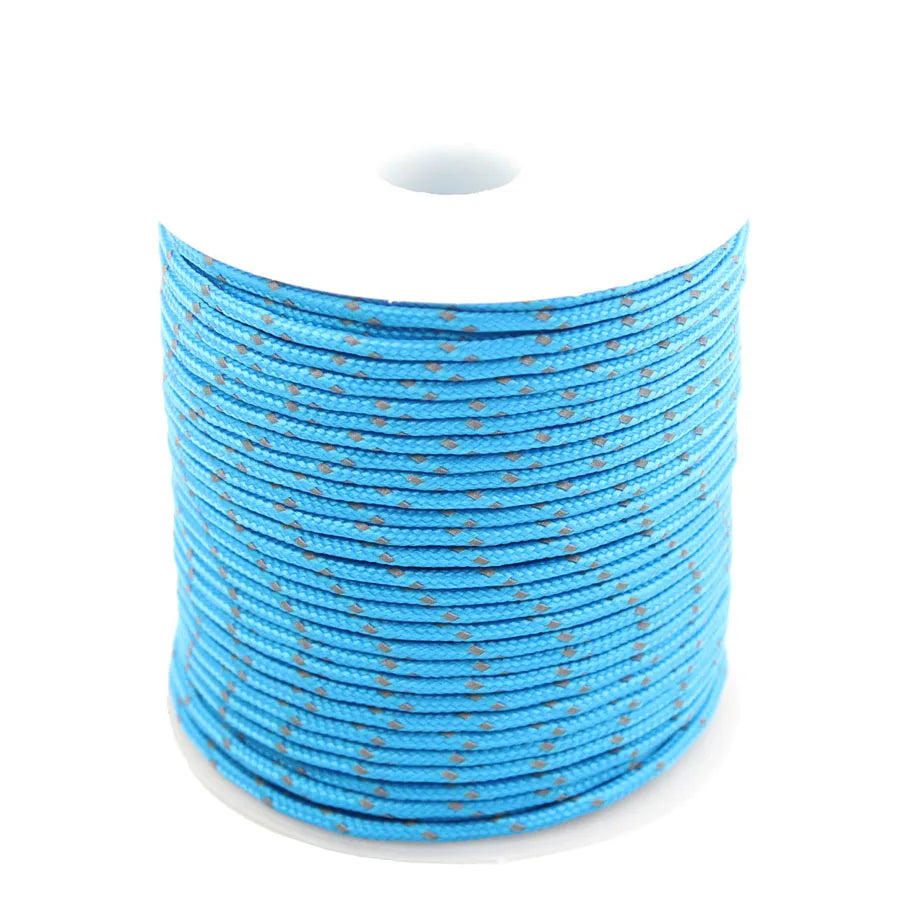 Spool of blue reflective paracord rope coiled on a white background