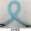 A blue braided rope used for gift wrapping, shown in an 'X' shape.