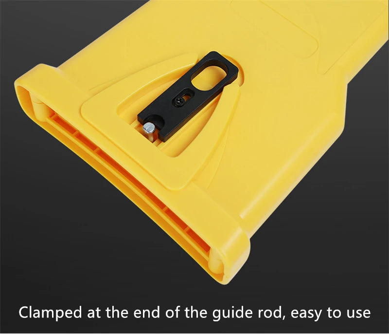 Yellow portable chainsaw tooth sharpening kit clamped at the end of a guide rod