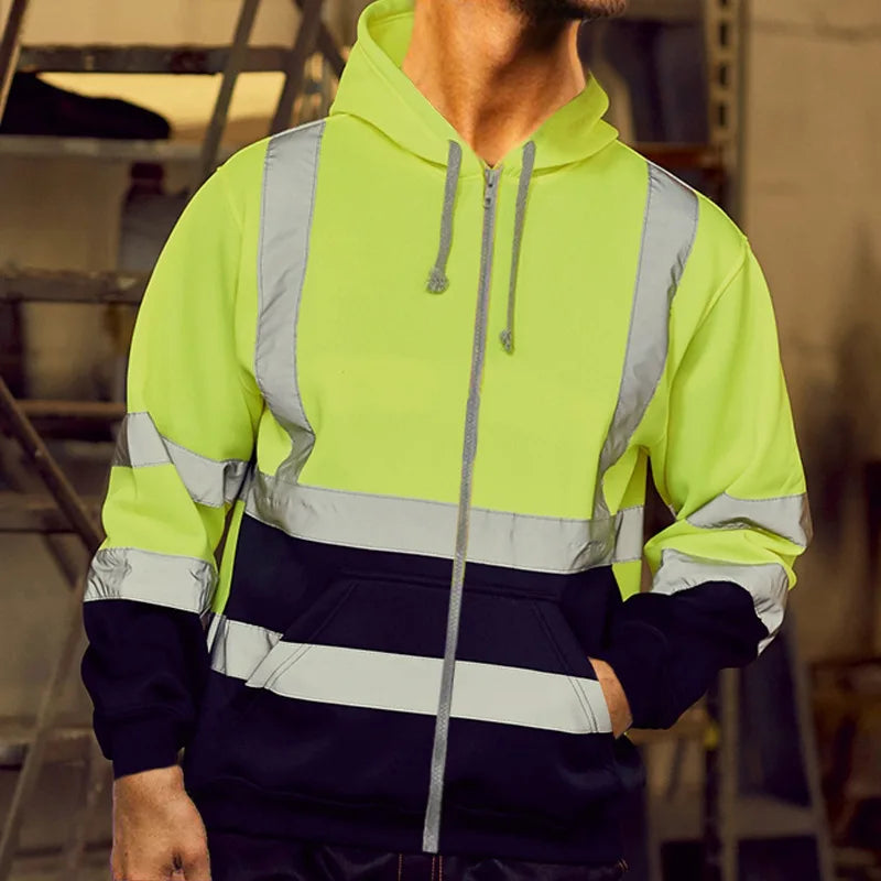 A man wearing a bright lime green reflective winter zipper hoodie.