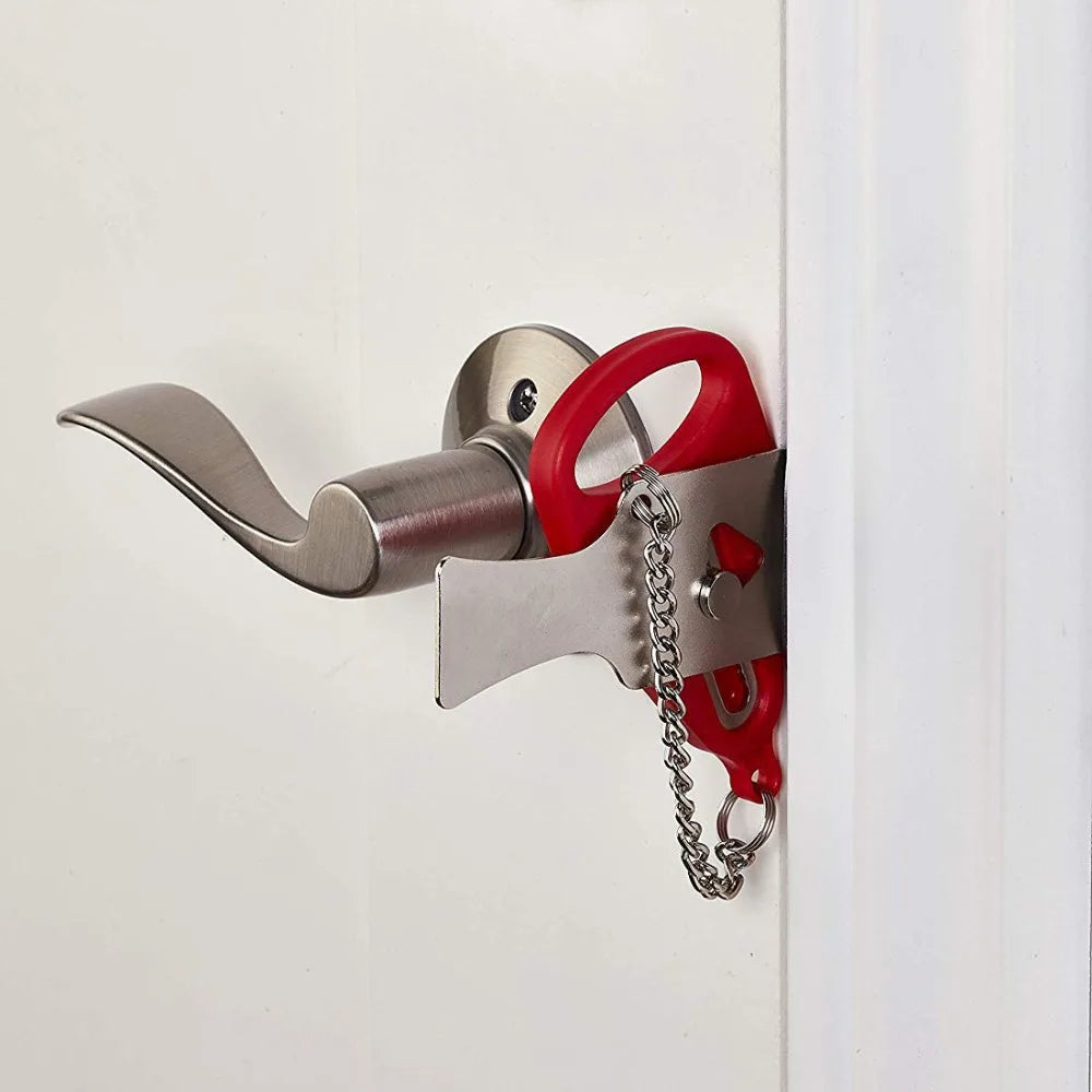 A portable keyless door lock with a silver body and red handle is mounted on a white door frame.