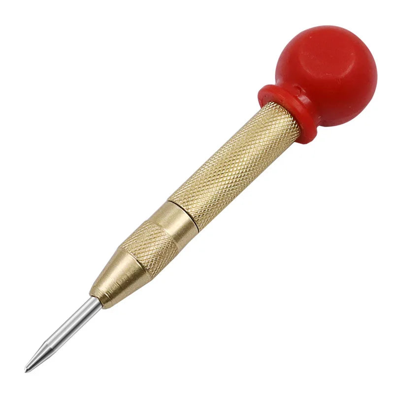 A spring-loaded center pin punch with a brass body and a red spherical tip.