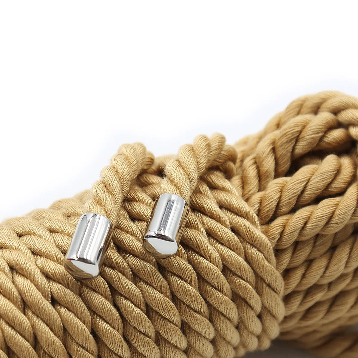 A close-up of a thick, golden beige silky bondage rope set with silver metal ends.