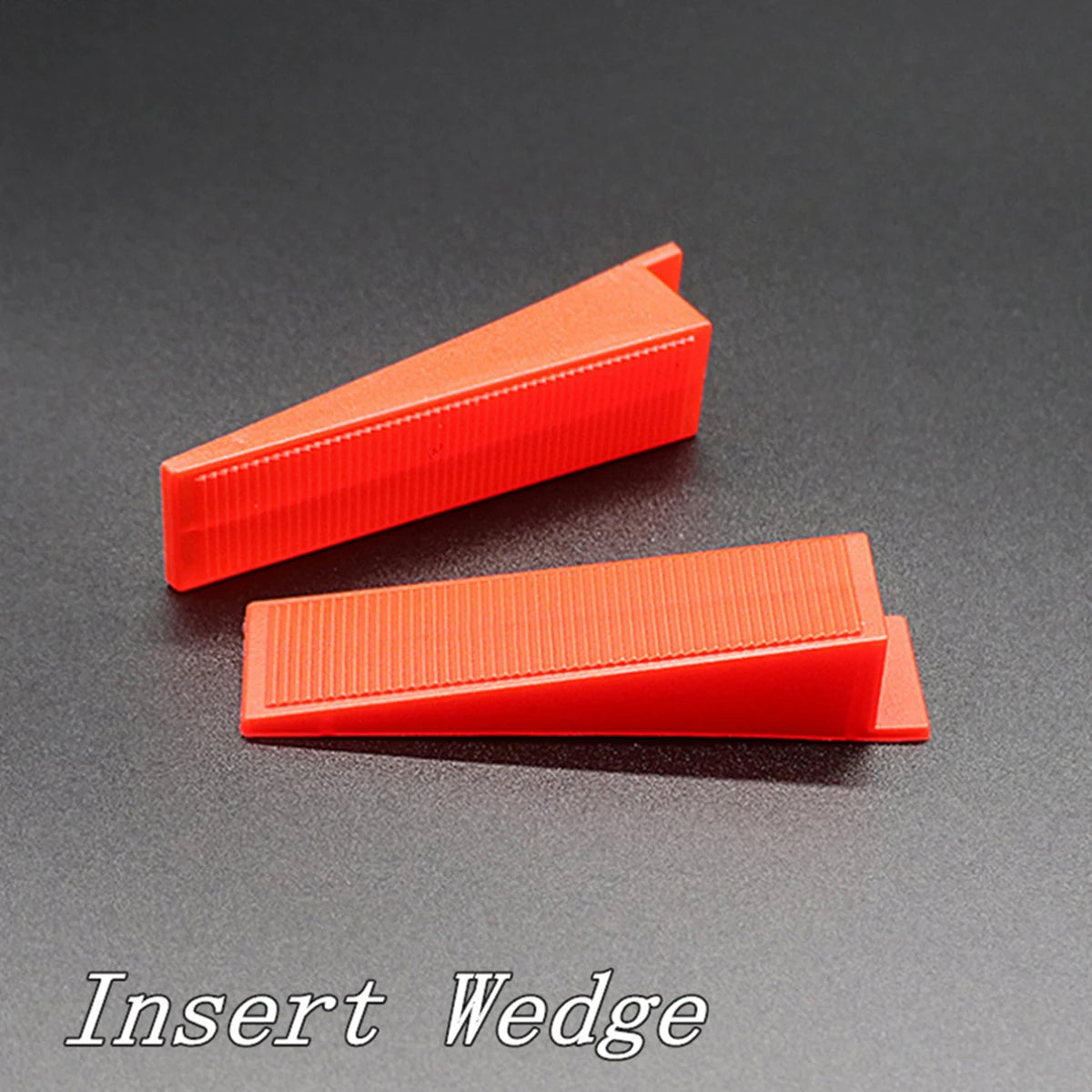 An orange insert wedge used as a precision tile leveling spacer for construction.
