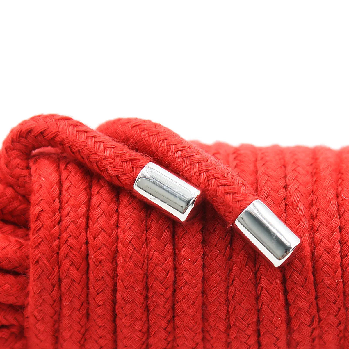 A close-up of a bright red braided rope with silver metal tips.