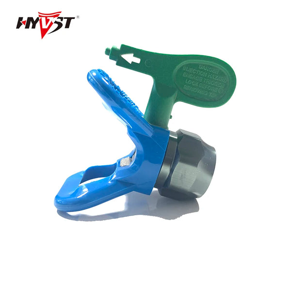 A green and blue airless paint sprayer tip guard nozzle seat with a protective cover.