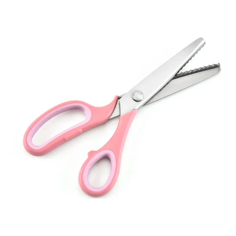 A pair of pink and silver stainless steel zigzag tailor scissors.