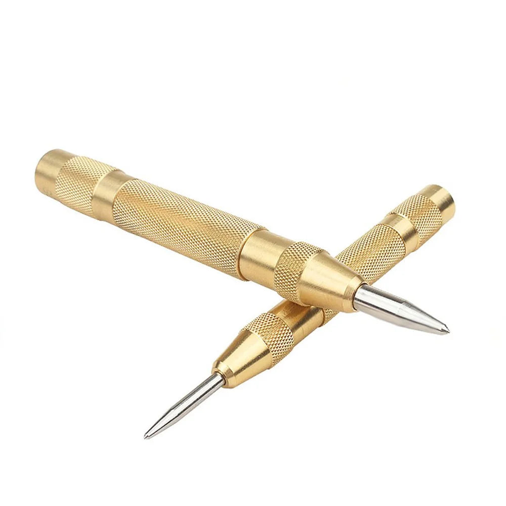 A gold-colored spring-loaded center pin punch tool for woodworking and repair.