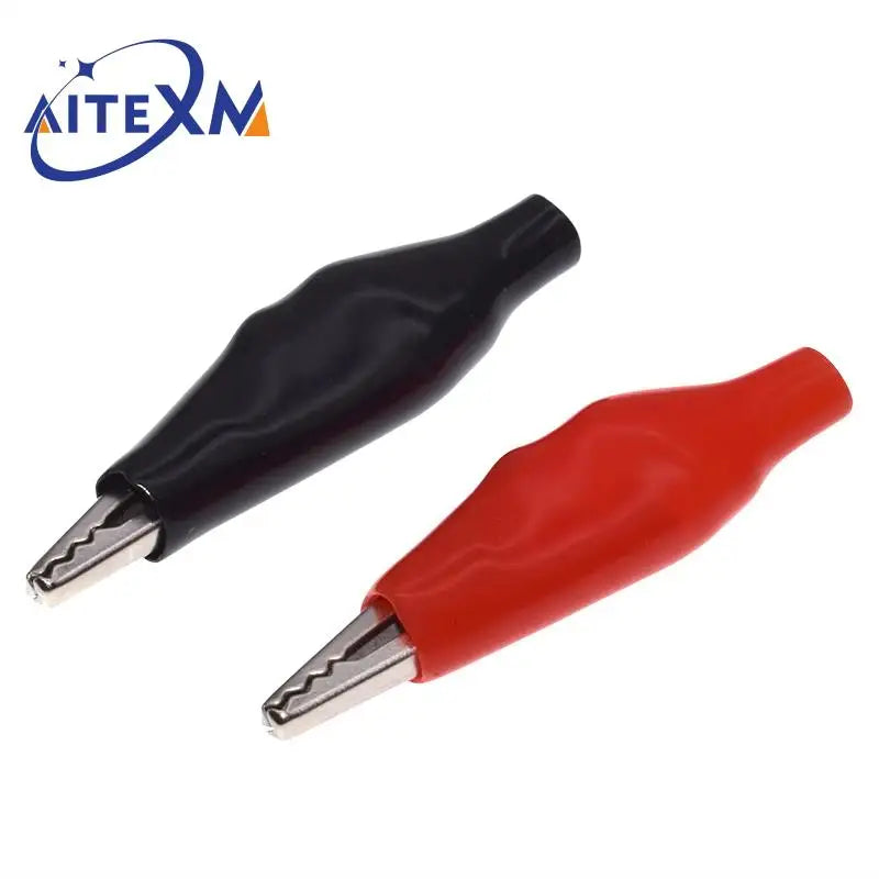 A pair of precision alligator clips, one black and one red, used for electrical testing.