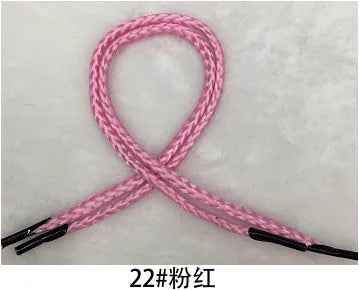 Pink polypropylene gift wrapping rope tied in an 'X' shape.