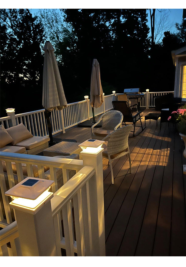 Outdoor deck featuring solar LED post cap lights illuminating the railing and pathway.