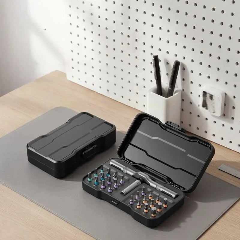 A black 24-in-1 multifunction ratchet screwdriver set is displayed on a light surface next to a white organizer.