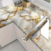 Marble self-adhesive waterproof contact paper featuring gold veining on a kitchen countertop.