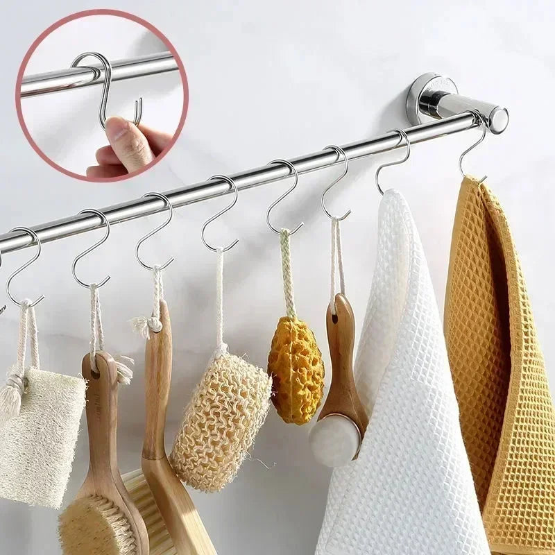 A set of stainless steel hanging hooks used for drying kitchen utensils and tools.