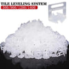 A pile of clear plastic tile leveling spacers in various sizes (500/900/1200/1400) for construction
