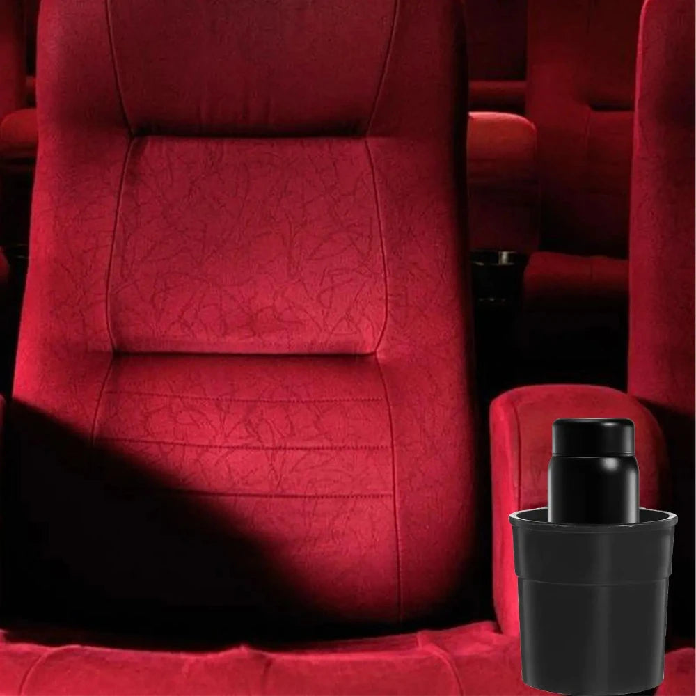 A close-up of a red upholstered chair with a black cup holder rack placed on the seat.