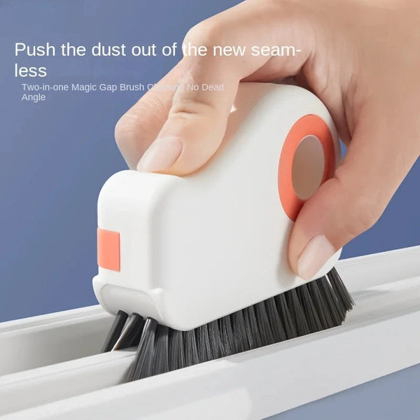 A hand is using a white two-in-one magic gap brush to clean dust from a window track.