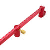 A red precision drawing circle ruler with a brass adjustment knob and markings.