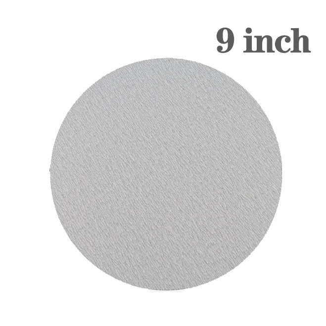 A round, gray sanding pad holder measuring 9 inches.