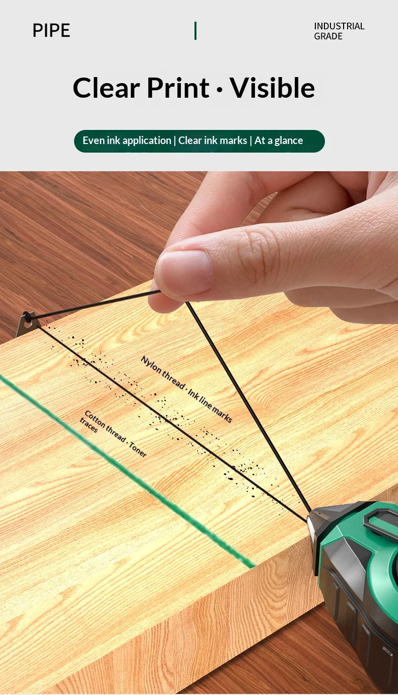 A hand uses a tool to draw ink line marks on a wooden surface, demonstrating clear print visibility.