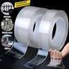Rolls of heavy-duty transparent double-sided adhesive tape shown with usage examples in kitchen, washroom, and office setting