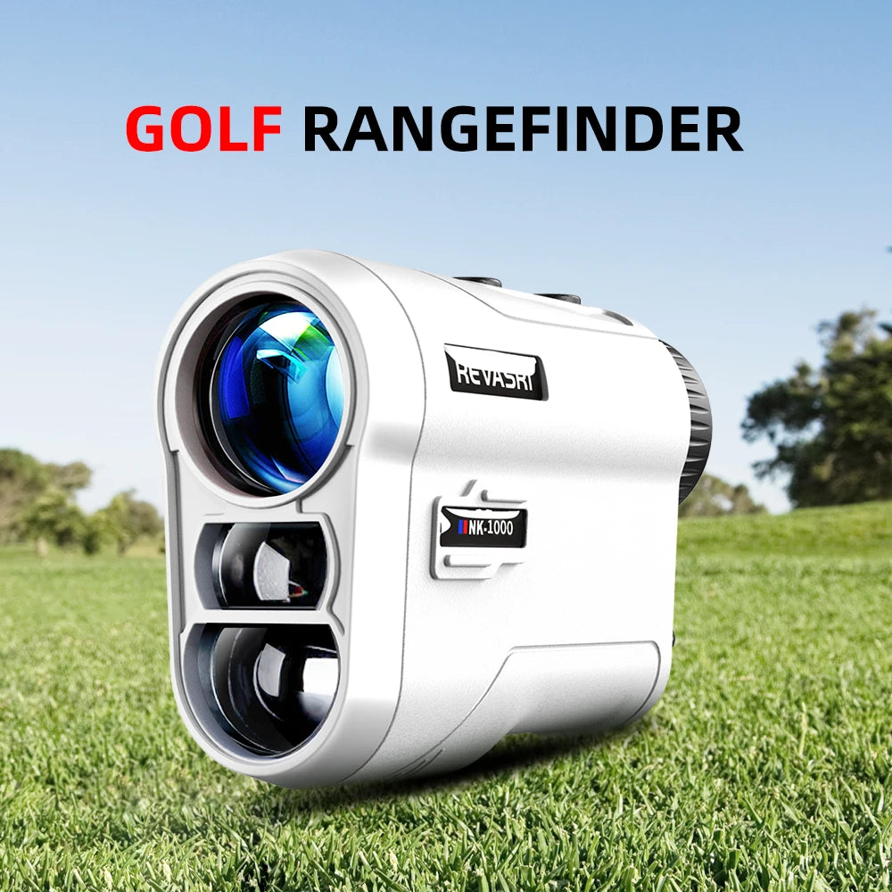 A silver golf rangefinder device is shown resting on green grass under a blue sky.